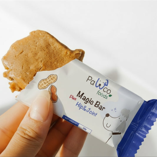 PawCo Magic Bar Hip & Joint – half-unwrapped bar held in hand, showing inside – PawCo Foods