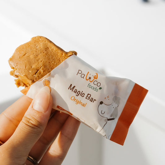 PawCo Magic Bar Original – half-unwrapped bar held in hand, showing inside – PawCo Foods